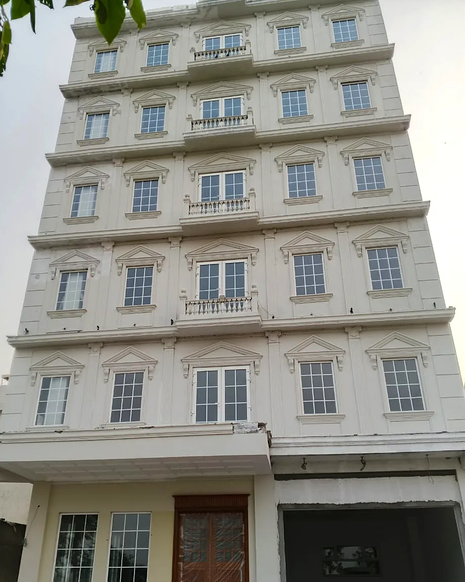 Apartment building: Georgian-bar windows and French balconies