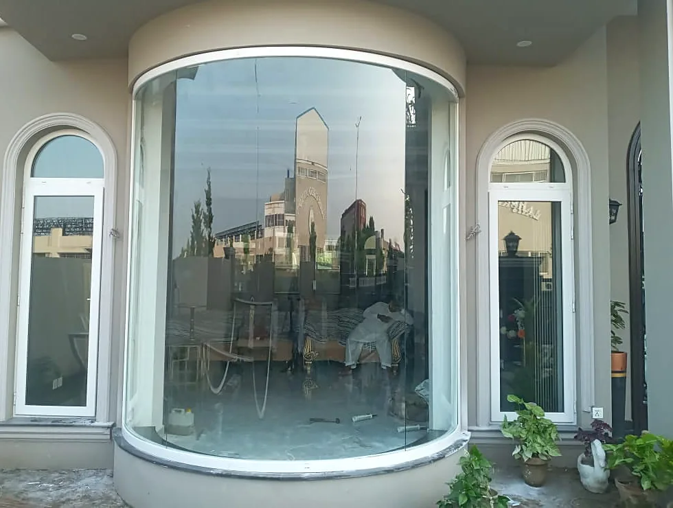Curved fixed glazing between two arched uPVC windows