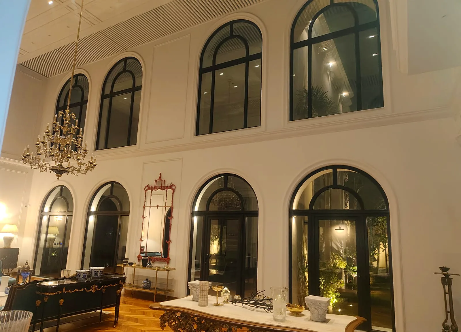 Black arched uPVC windows and French doors in a double-height hall