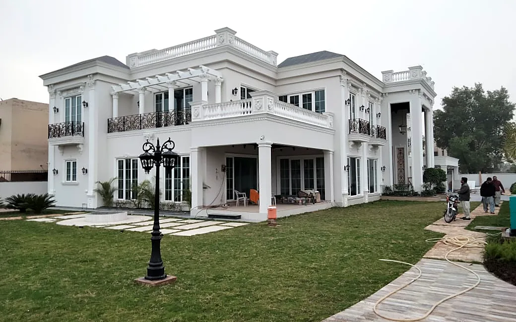 White villa with lawn: Sliding patio doors and French windows