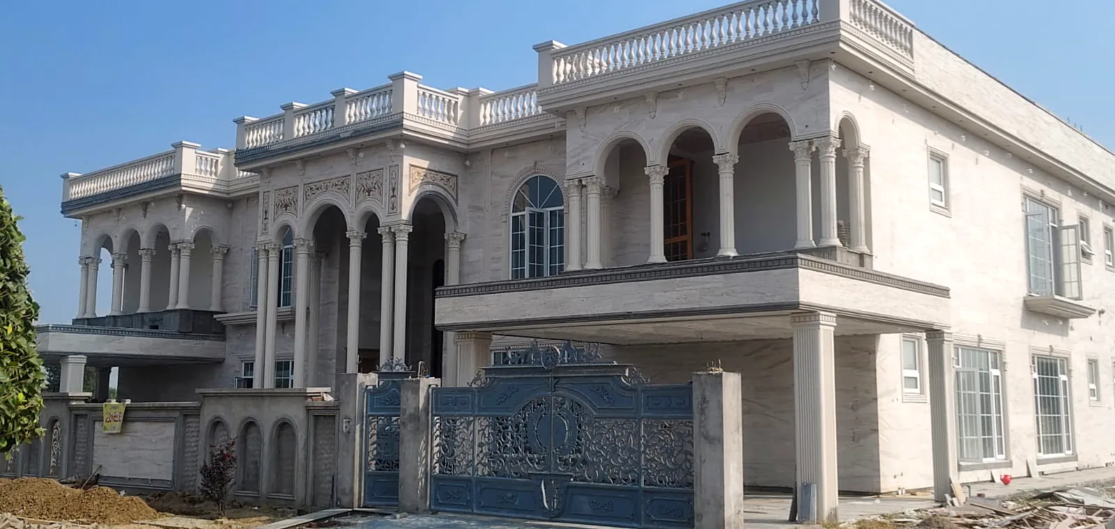 Marble-clad residence with white uPVC casement and arched windows by Window Concept
