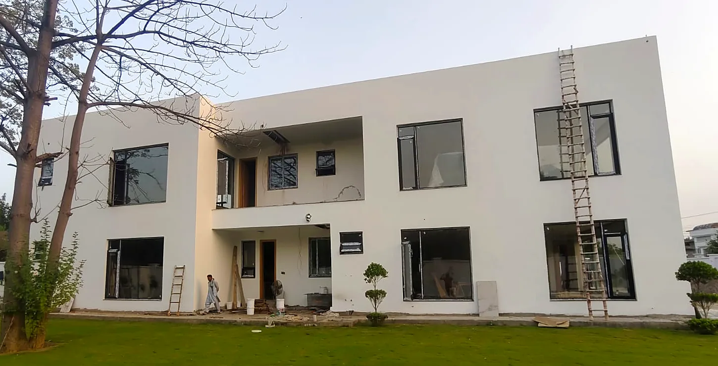 Minimal white house: Black uPVC windows during fit-out