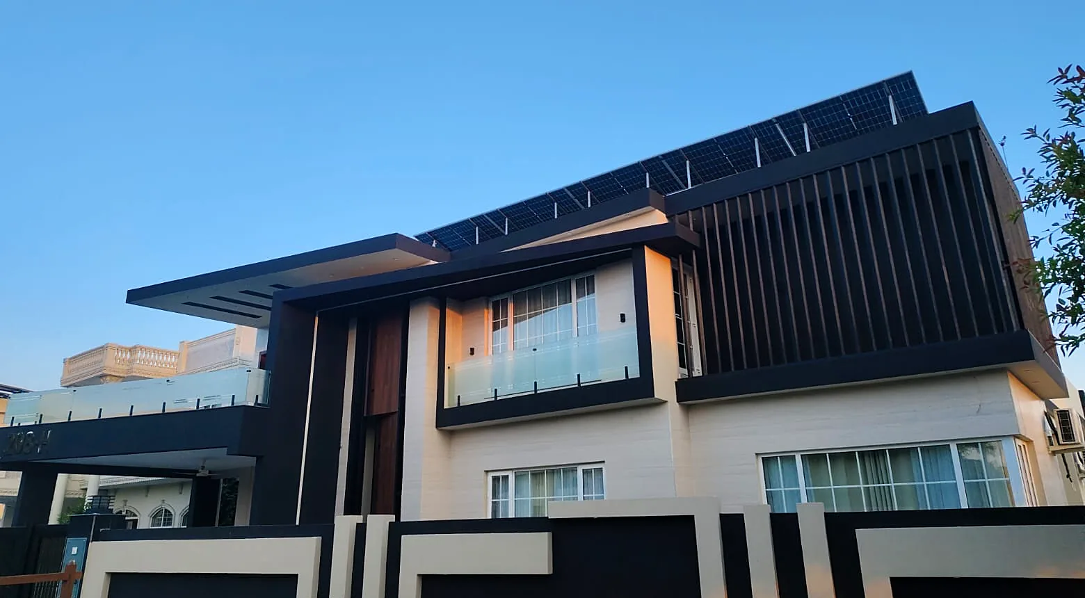 Contemporary home: White Georgian-bar windows, glass balconies
